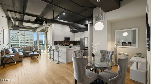 a view of a dining room with furniture window and wooden floor
