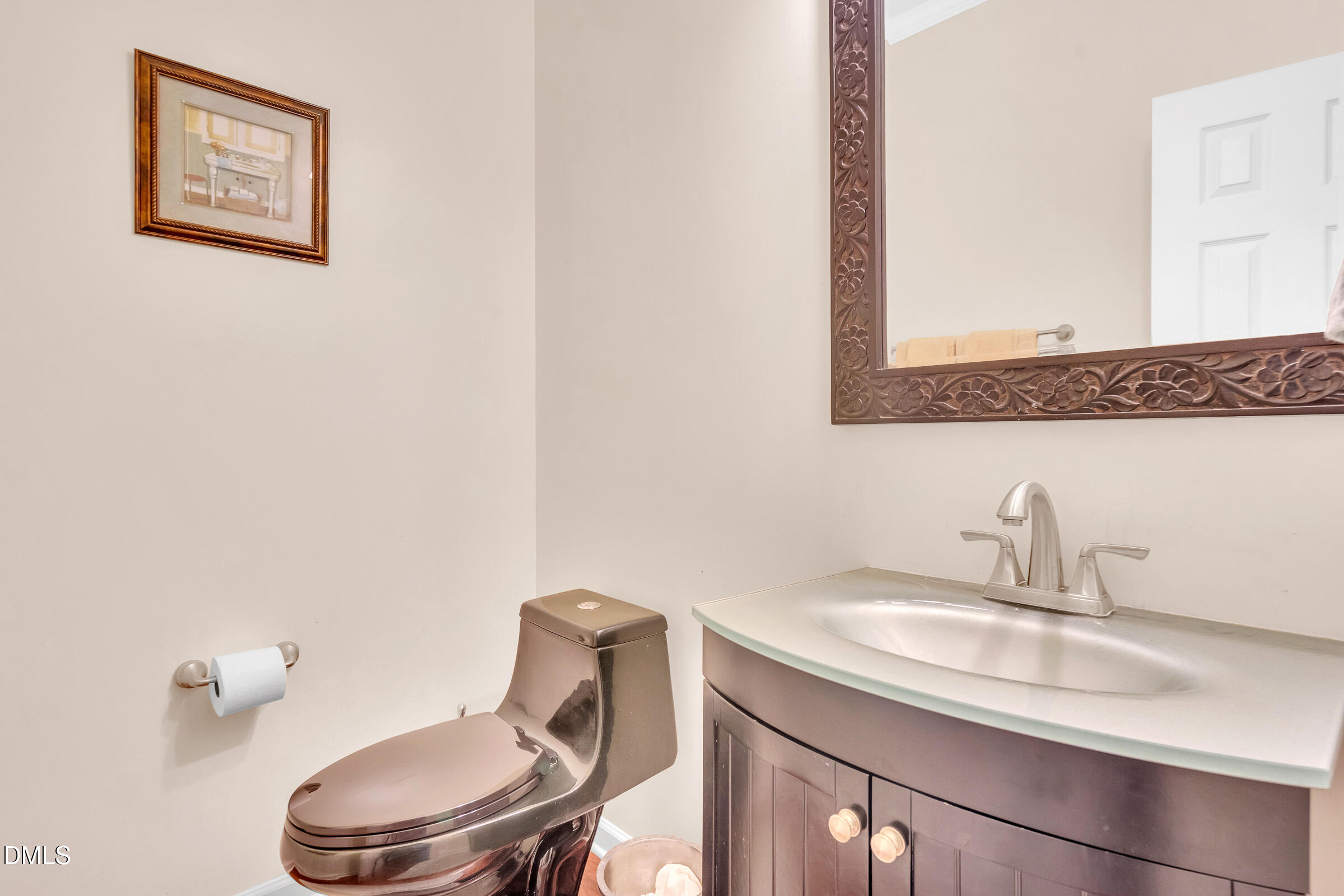 5165 Busted Rock Trail Raleigh, NC 27610 - Photo 11 of 18 a bathroom with a toilet a sink and mirror
