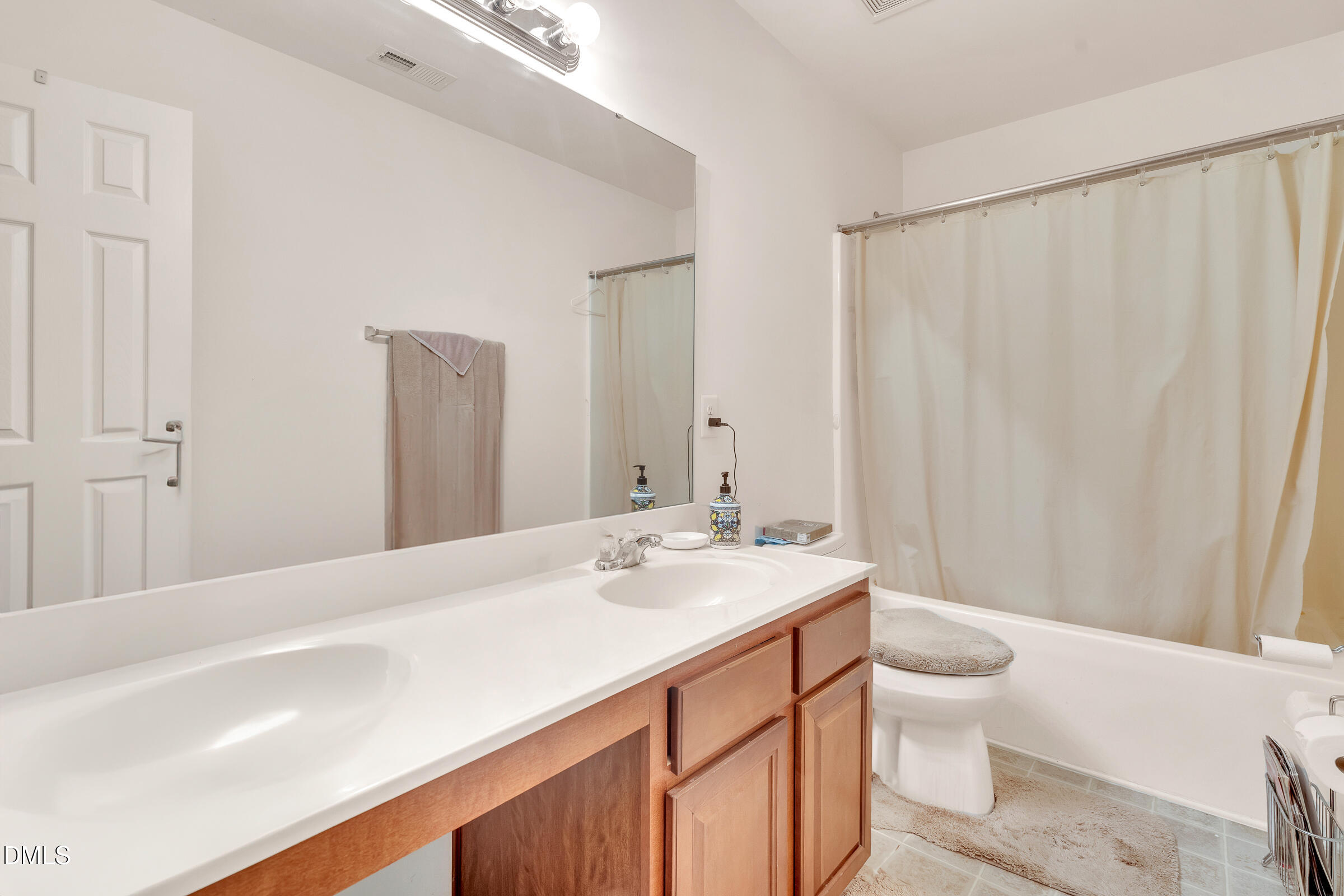 5165 Busted Rock Trail Raleigh, NC 27610 - Photo 18 of 18 a spacious bathroom with a sink a toilet and a large mirror