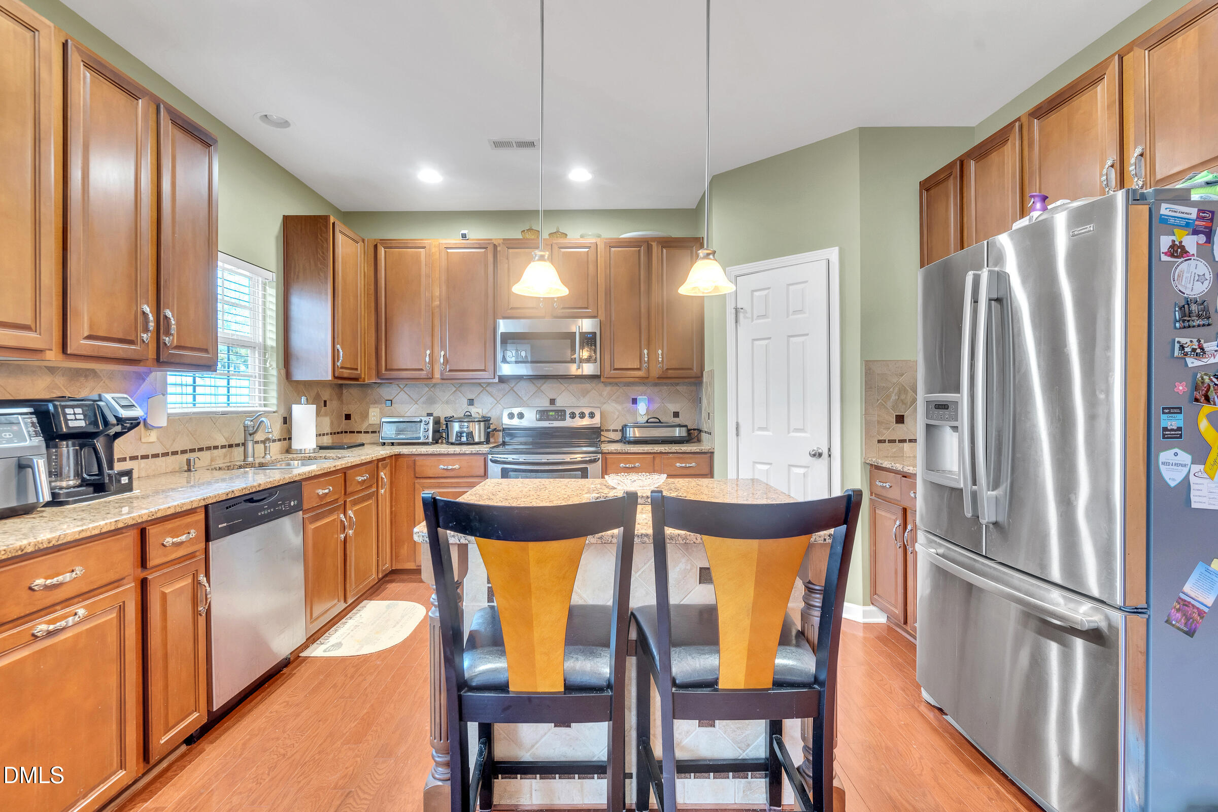 5165 Busted Rock Trail Raleigh, NC 27610 - Photo 7 of 18 a kitchen with stainless steel appliances granite countertop a refrigerator a sink a stove and island