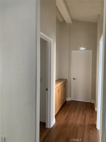 a view of a room with wooden floor