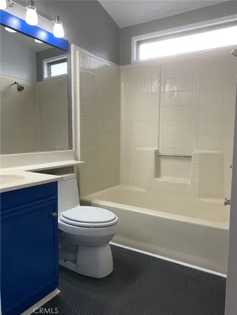 a bathroom with a white toilet sitting next to a bath tub