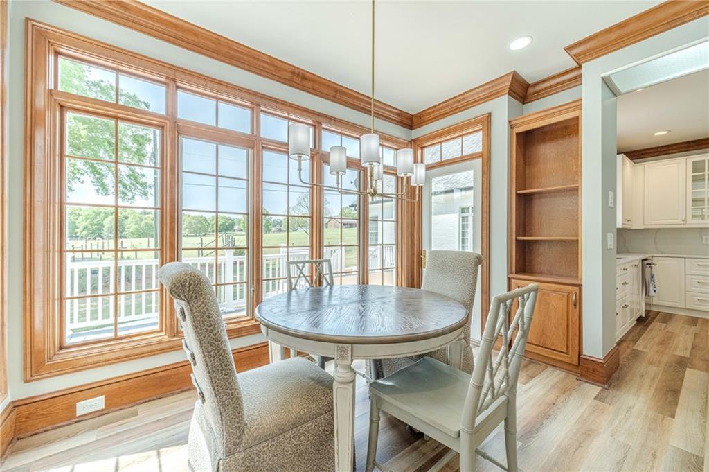1271 Carl Davis Road Northwest Monroe, GA 30656 - Photo 21 of 80 a dining room with furniture a chandelier and wooden floor