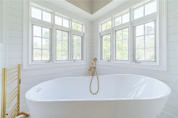 a spacious bedroom with a bed and a window