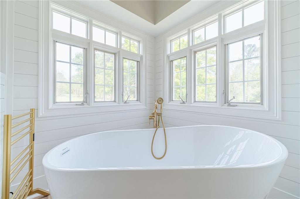 1271 Carl Davis Road Northwest Monroe, GA 30656 - Photo 30 of 80 a white bath tub sitting next to a window