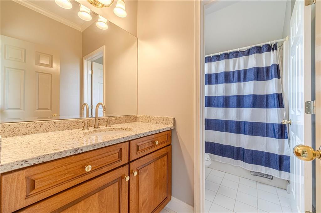 1271 Carl Davis Road Northwest Monroe, GA 30656 - Photo 50 of 80 a bathroom with a granite countertop sink a large mirror and a shower