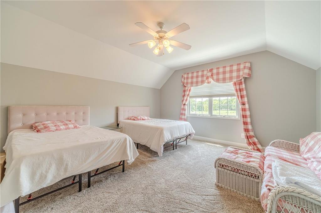 1271 Carl Davis Road Northwest Monroe, GA 30656 - Photo 54 of 80 a bedroom with two beds and a chandelier