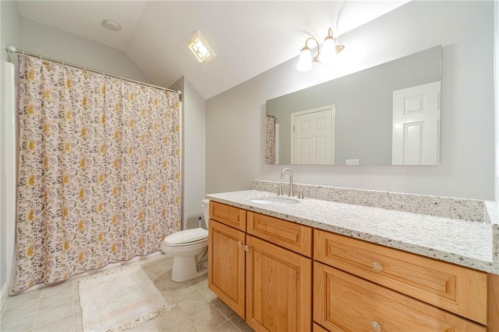 1271 Carl Davis Road Northwest Monroe, GA 30656 - Photo 55 of 80 a bathroom with a granite countertop sink a toilet and a mirror