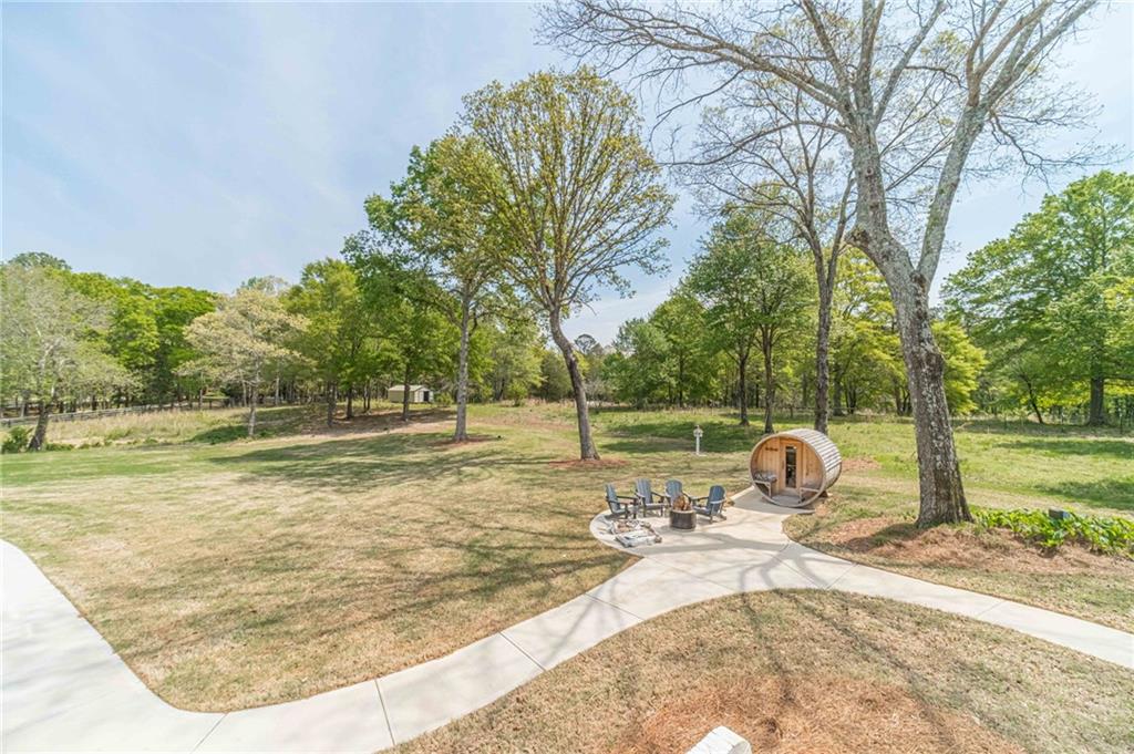 1271 Carl Davis Road Northwest Monroe, GA 30656 - Photo 75 of 80 a view of a swimming pool with a yard and sitting area