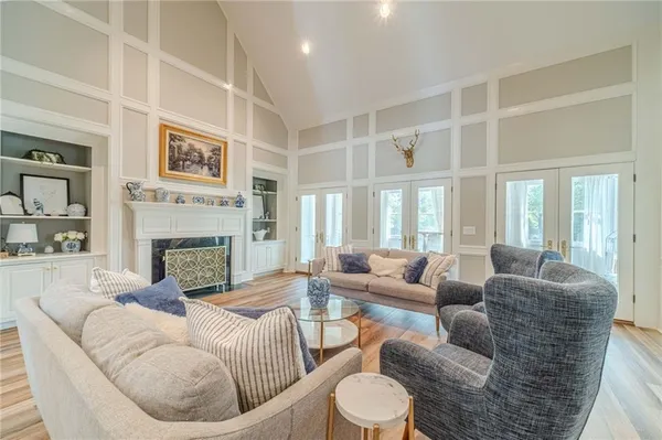 a living room with furniture large window and a fireplace
