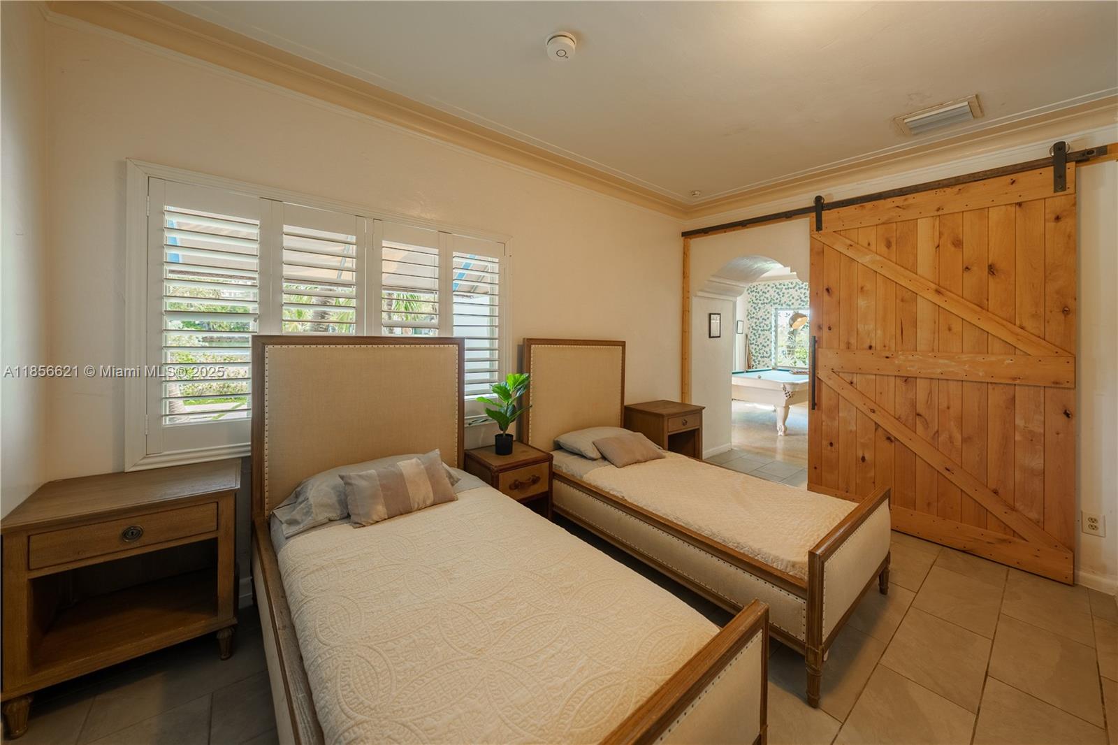 701 Hollywood Boulevard, Unit 701 Hollywood, FL 33019 - Photo 13 of 27 a bedroom with a bed and a window