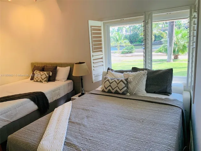 a bedroom with two beds and a chair