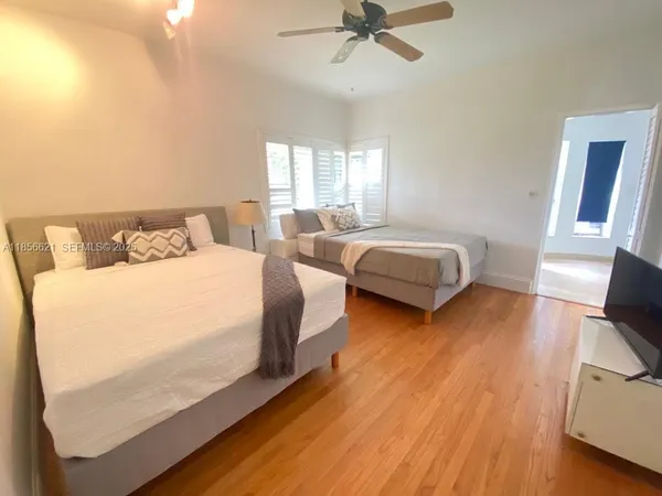 a bedroom with two beds and a chair