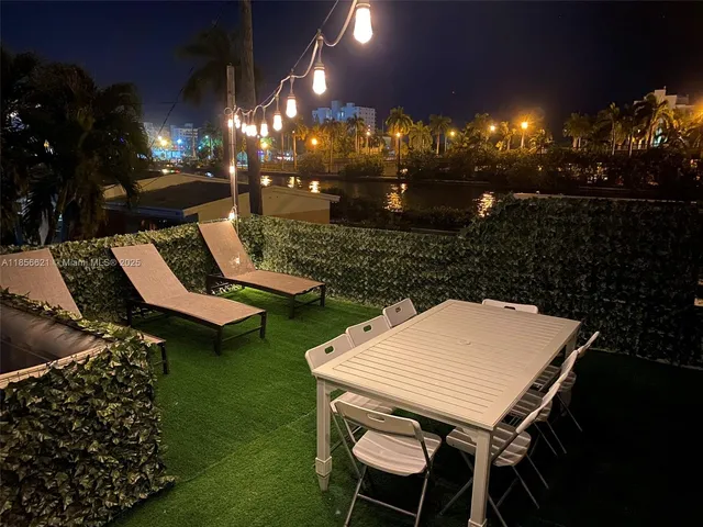 a view of a house with a swimming pool and sitting area