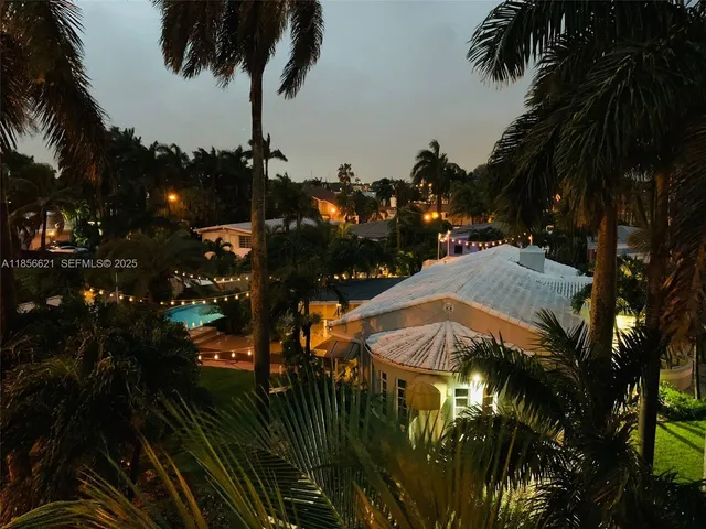 a view of a house with a swimming pool and sitting area