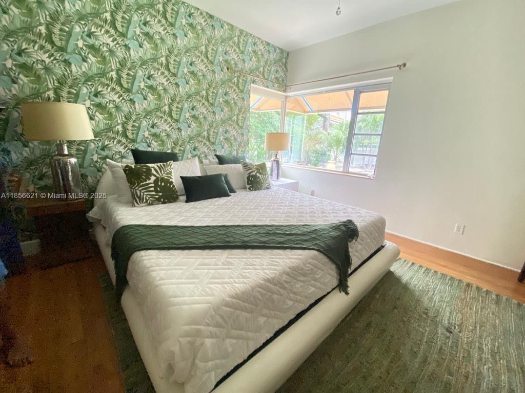 701 Hollywood Boulevard, Unit 701 Hollywood, FL 33019 - Photo 6 of 27 a bed sitting in a bedroom next to a window