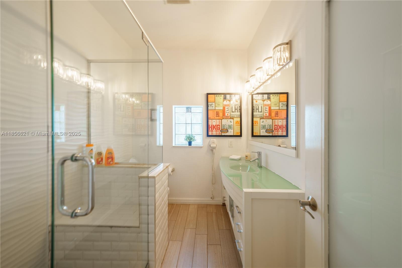 701 Hollywood Boulevard, Unit 701 Hollywood, FL 33019 - Photo 8 of 27 a bathroom with a tub sink and mirror