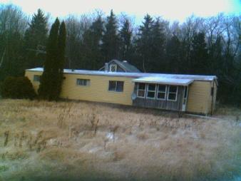 12 West Main Road Peru, MA 01235 - Photo 2 of 2 a front view of a house with a garden