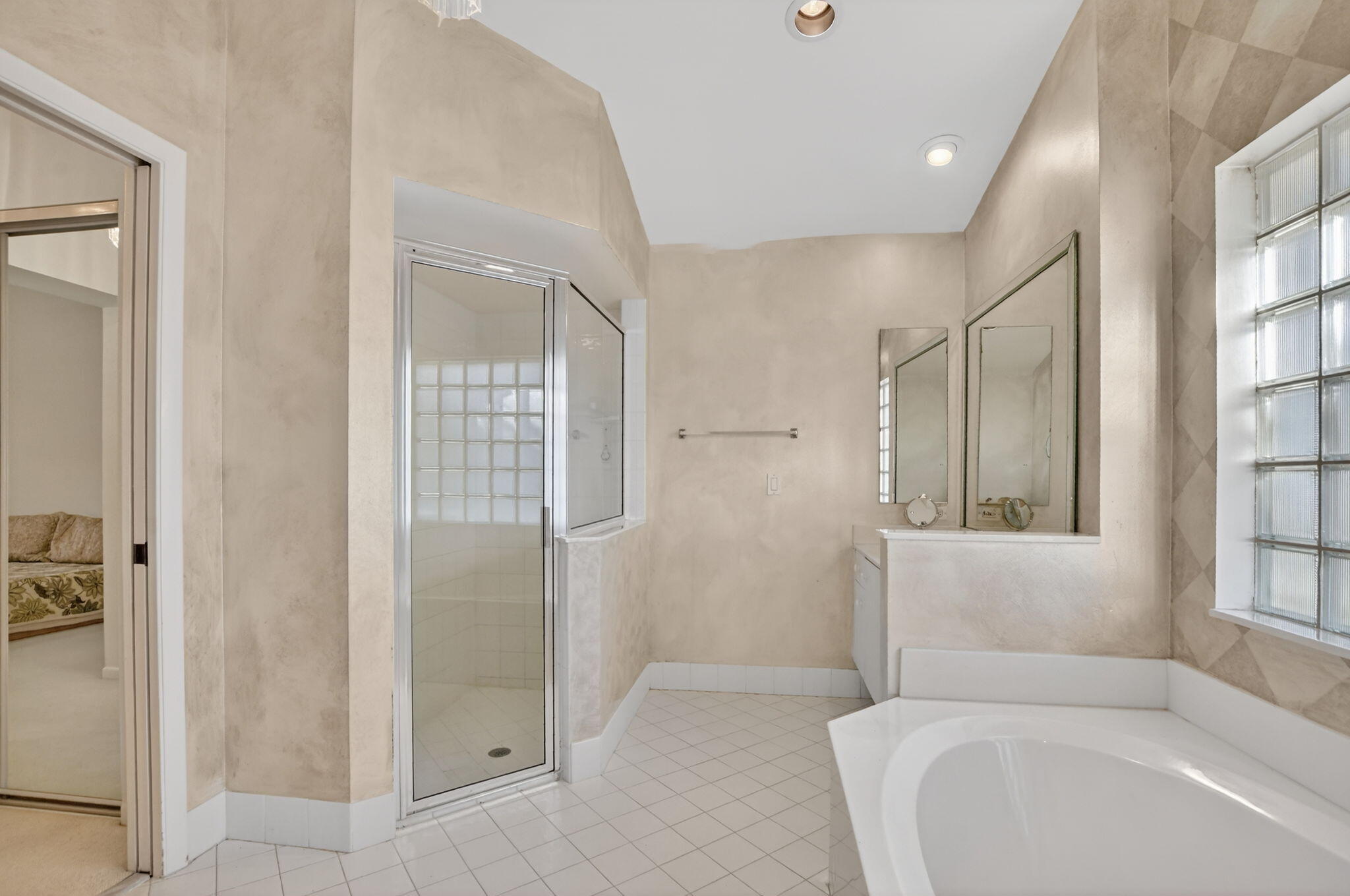 23429 Rakelle Circle Boca Raton, FL 33433 - Photo 20 of 75 a bathroom with a tub shower and sink