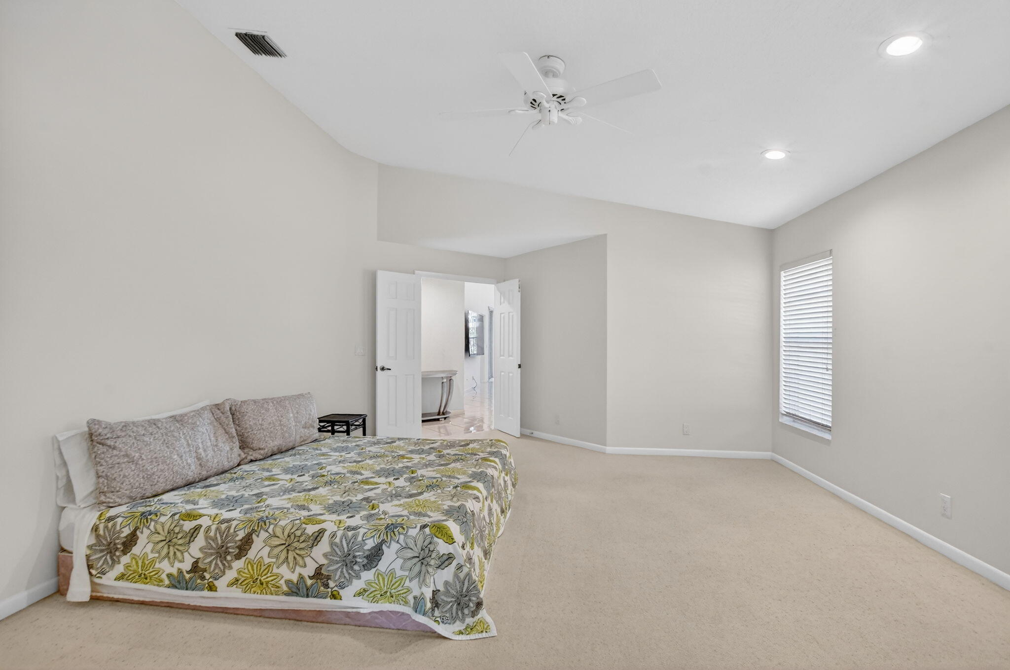 23429 Rakelle Circle Boca Raton, FL 33433 - Photo 61 of 75 a spacious bedroom with a bed and a window