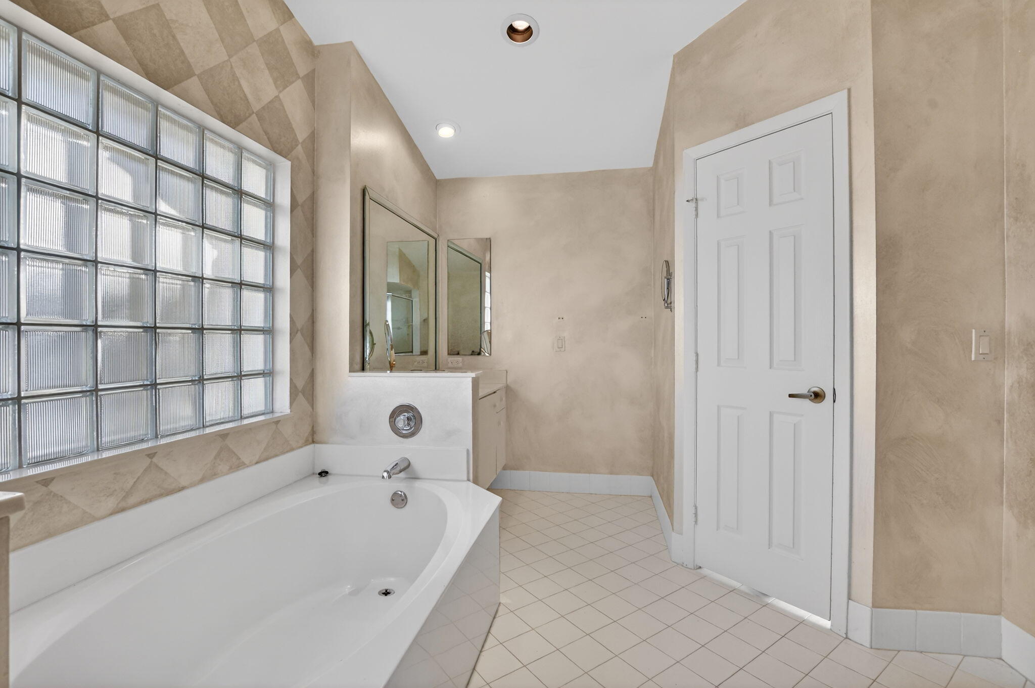 23429 Rakelle Circle Boca Raton, FL 33433 - Photo 63 of 75 a bathroom with a bathtub and a shower
