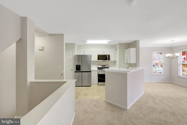 a kitchen with stainless steel appliances a refrigerator stove and sink