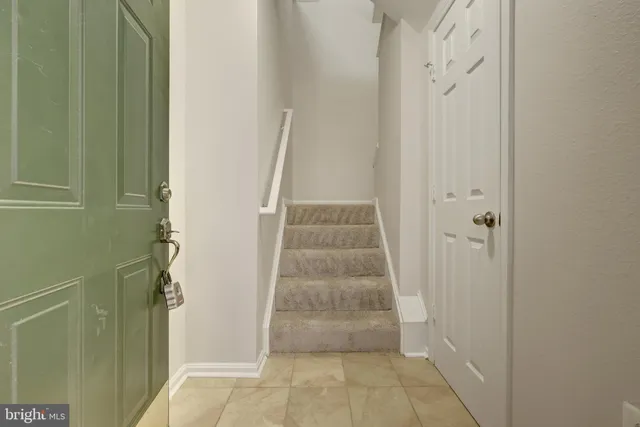 a view of a hallway with white door and door