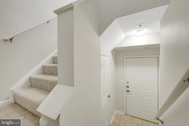 a living room with furniture and a ceiling fan