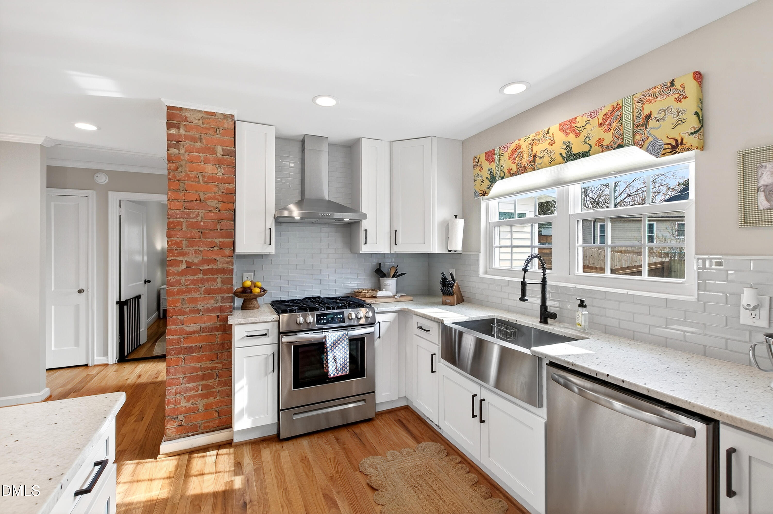 1802 Rankin Street Raleigh, NC 27604 - Photo 10 of 37 a kitchen with stainless steel appliances granite countertop a stove a sink and a refrigerator