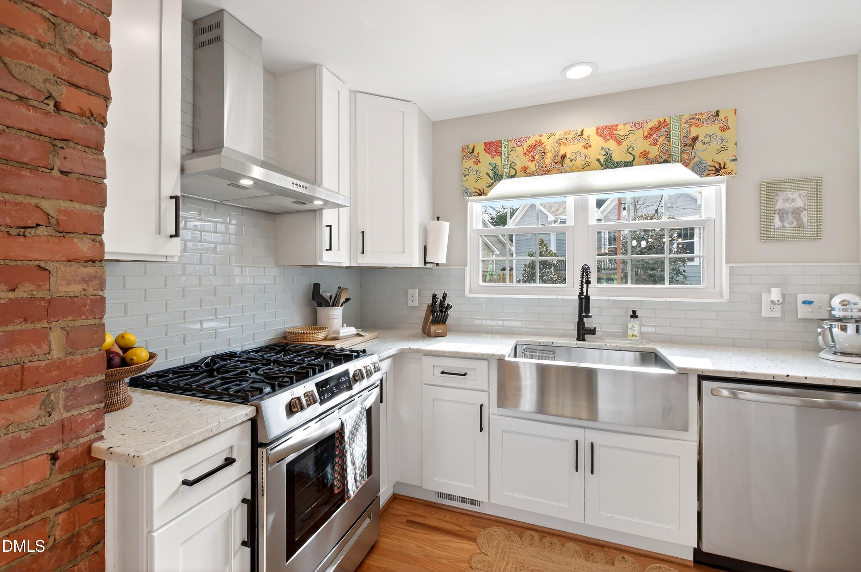 1802 Rankin Street Raleigh, NC 27604 - Photo 12 of 37 a kitchen with cabinets appliances a sink and a window