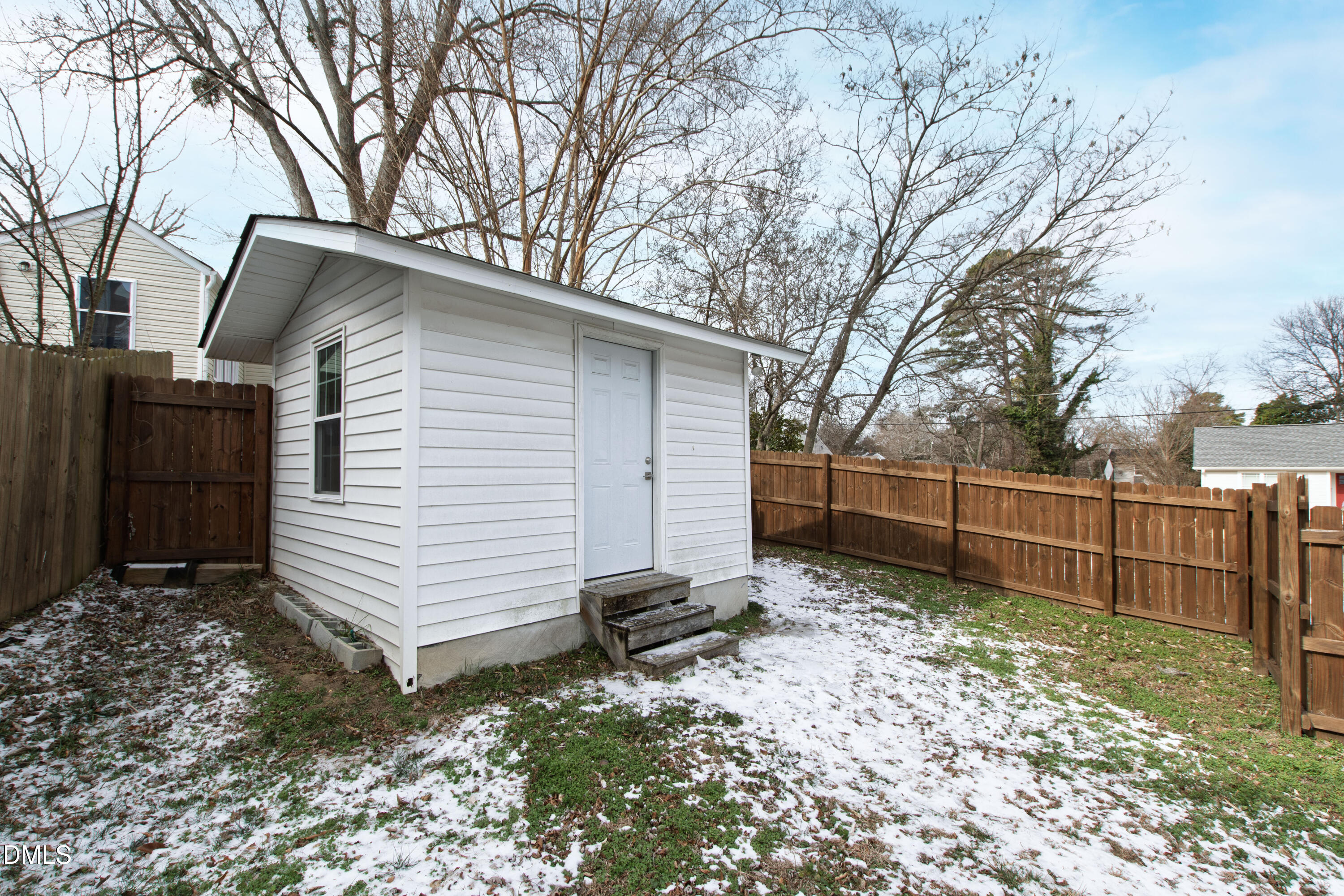 1802 Rankin Street Raleigh, NC 27604 - Photo 31 of 37 a backyard of a house with a large tree and wooden fence