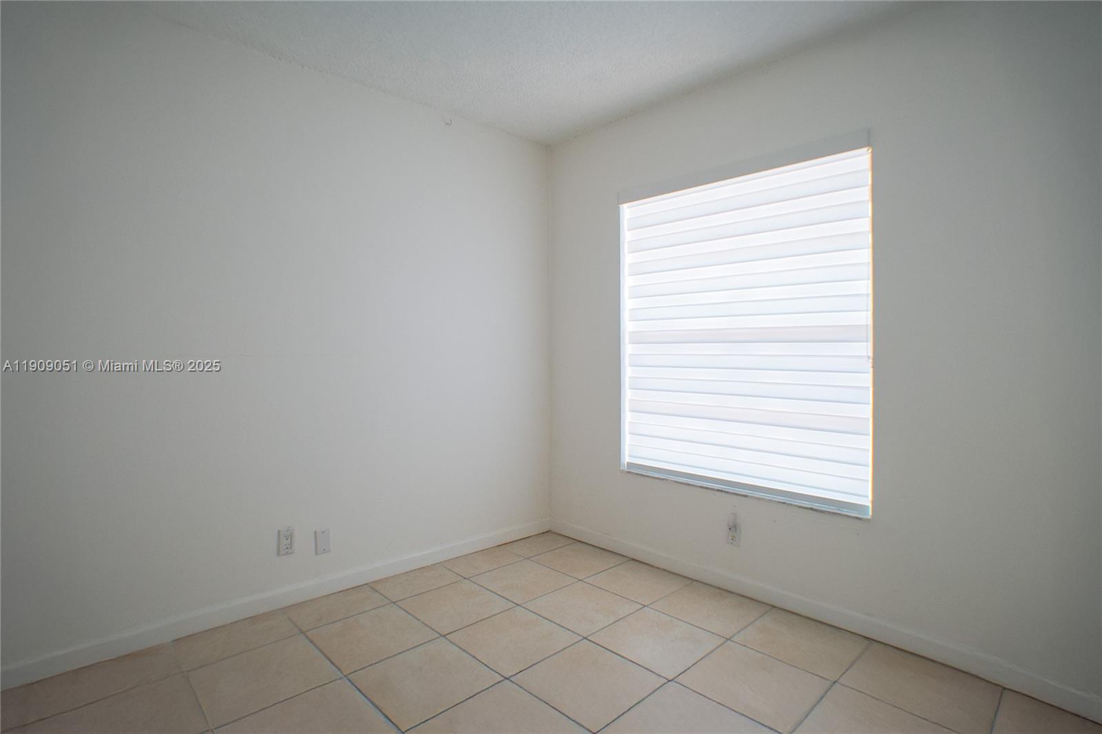 12800 Southwest 43rd Drive, Unit 210B Miami, FL 33175 - Photo 15 of 25 an empty room with a window