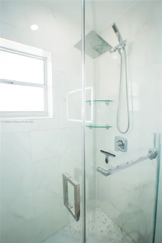 a bathroom with a glass shower door