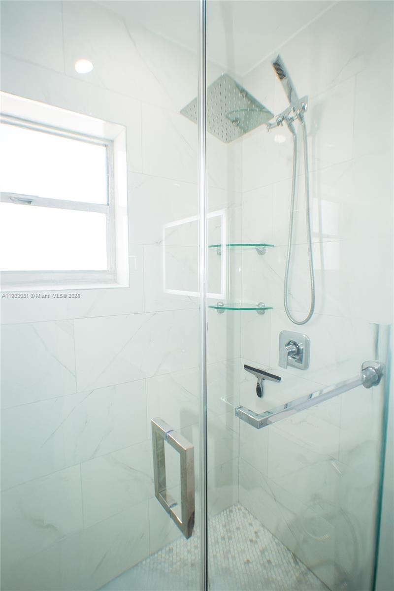 12800 Southwest 43rd Drive, Unit 210B Miami, FL 33175 - Photo 20 of 25 a bathroom with a glass shower door