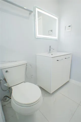 a white toilet sitting next to a bathroom sink