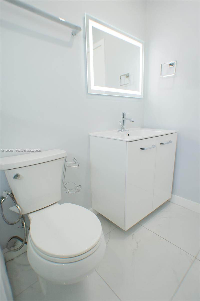 12800 Southwest 43rd Drive, Unit 210B Miami, FL 33175 - Photo 21 of 25 a white toilet sitting next to a bathroom sink