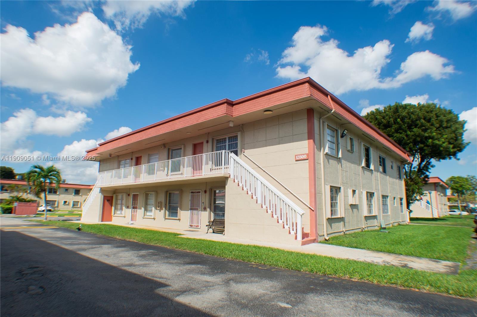 12800 Southwest 43rd Drive, Unit 210B Miami, FL 33175 - Photo 4 of 25 a front view of a house with a garden and trees
