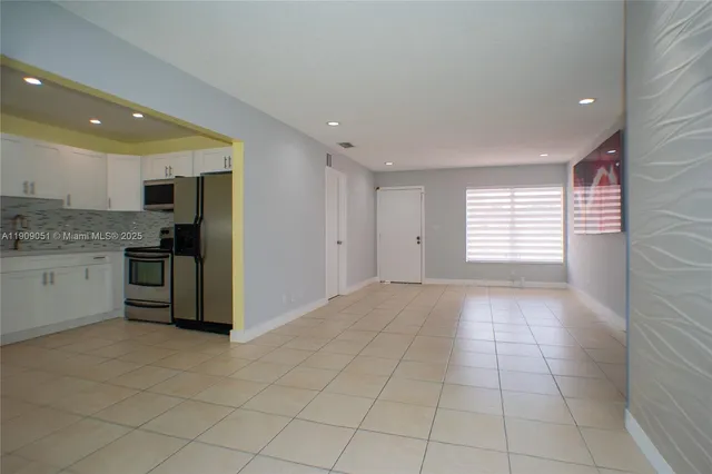 a view of a kitchen with a sink and dishwasher cabinets