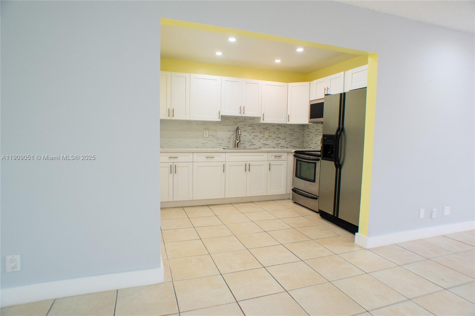 12800 Southwest 43rd Drive, Unit 210B Miami, FL 33175 - Photo 10 of 25 a kitchen with stainless steel appliances granite countertop a sink and cabinets