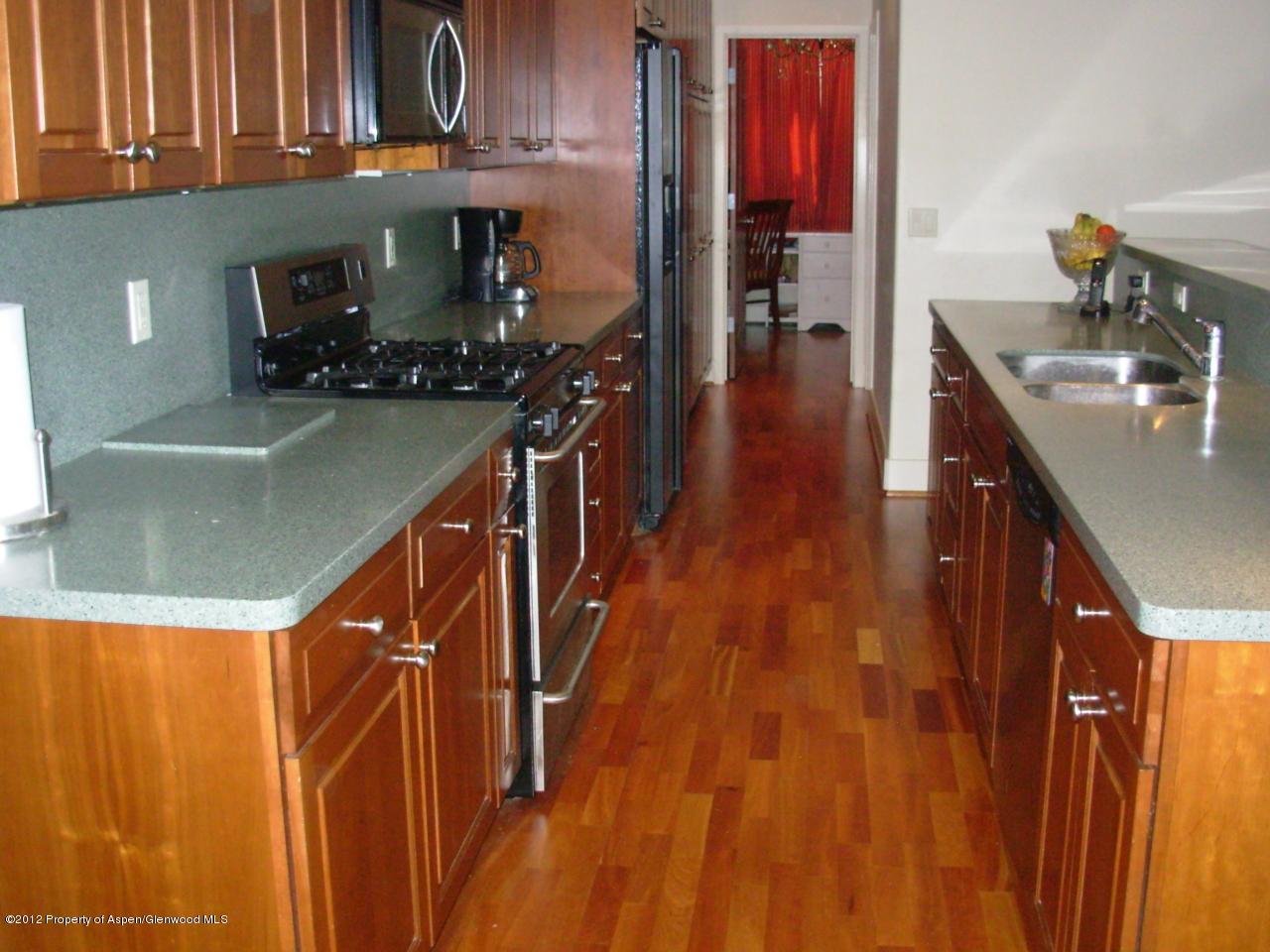 405 Meadow Court Basalt, CO 81621 - Photo 12 of 25 a kitchen with wooden cabinets and a sink
