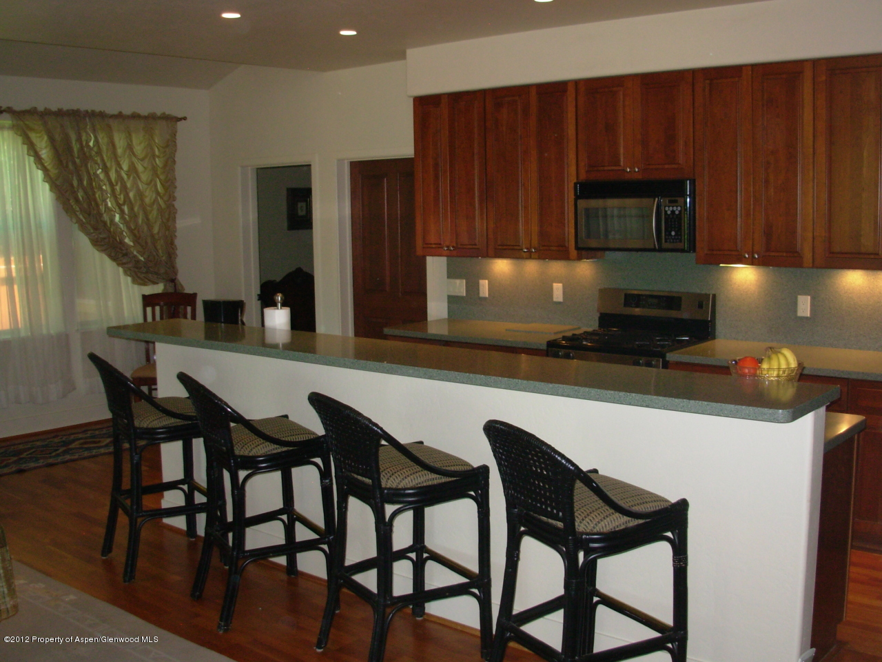 405 Meadow Court Basalt, CO 81621 - Photo 13 of 25 a kitchen with a table chairs microwave and cabinets