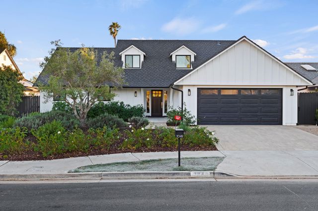 a front view of a house with garage