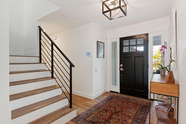 a view of an entryway with wooden floor