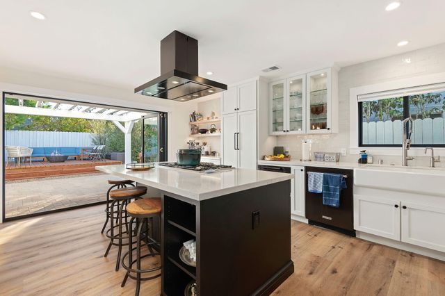 a kitchen with a stove a sink and a refrigerator