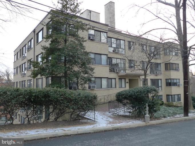 a front view of a residential apartment building with a yard