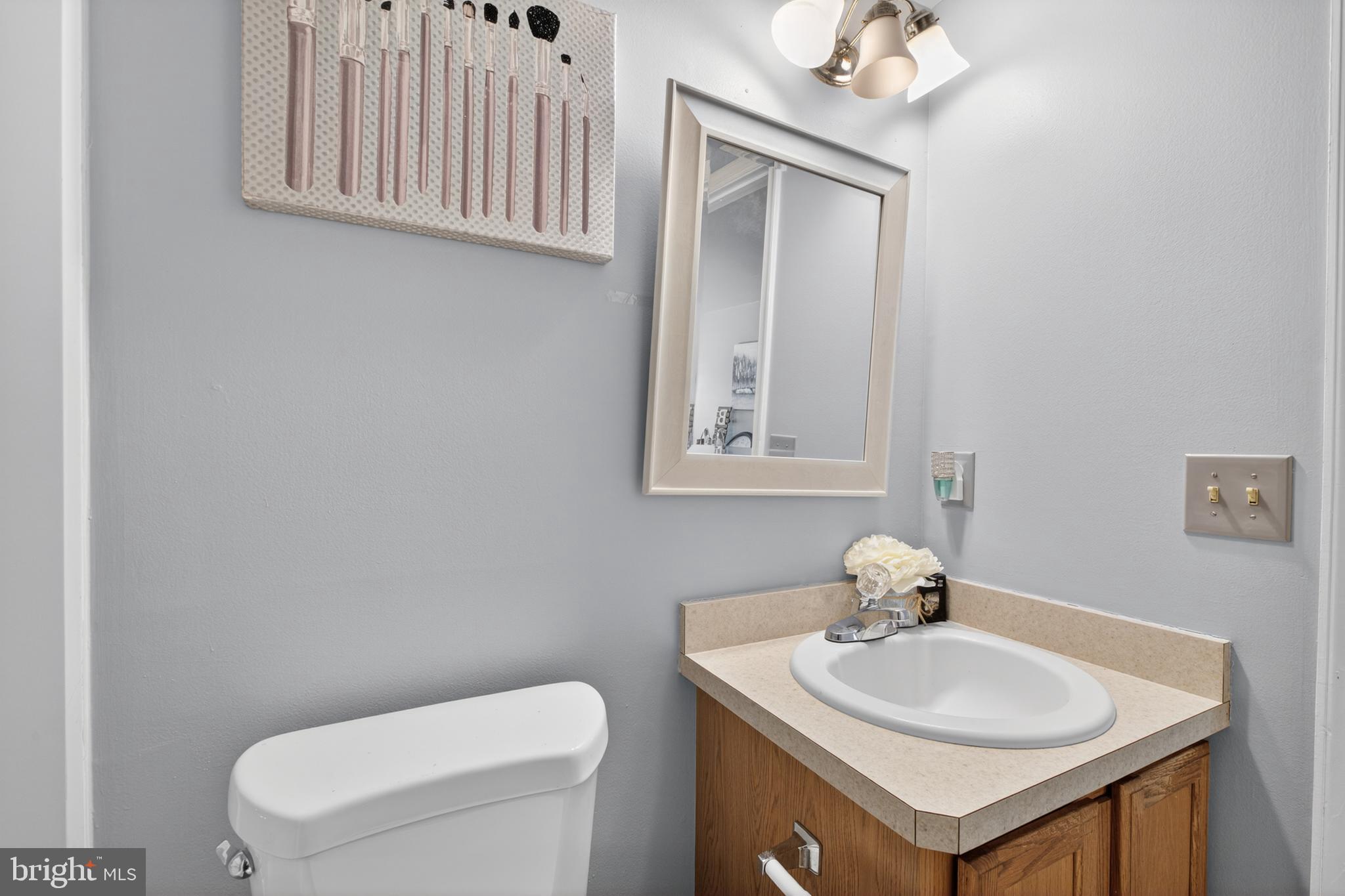115 Bonnybrook Road Middletown, DE 19709 - Photo 25 of 31 a bathroom with a toilet a sink and a mirror