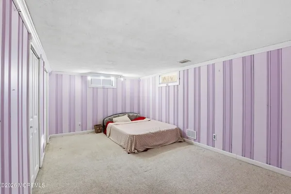 a living room with a bed and curtain