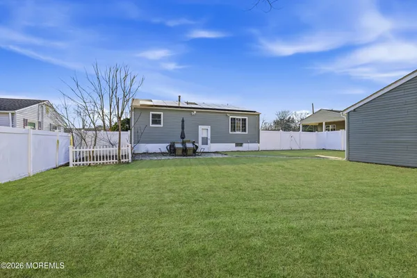 a backyard of a house with table and chairs