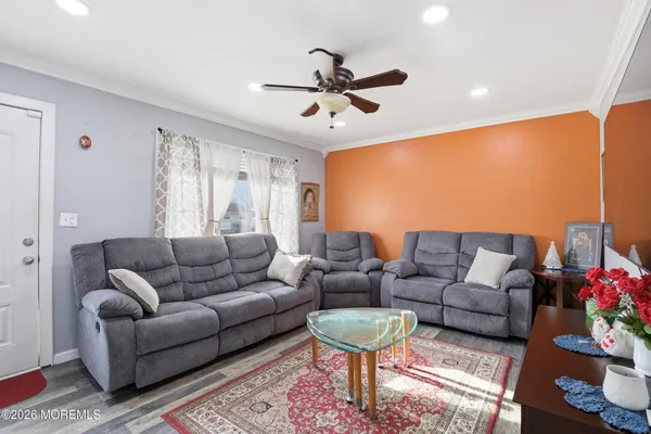a living room with furniture ceiling fan and a rug