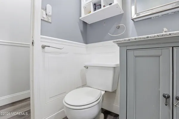 a white toilet sitting next to a shower